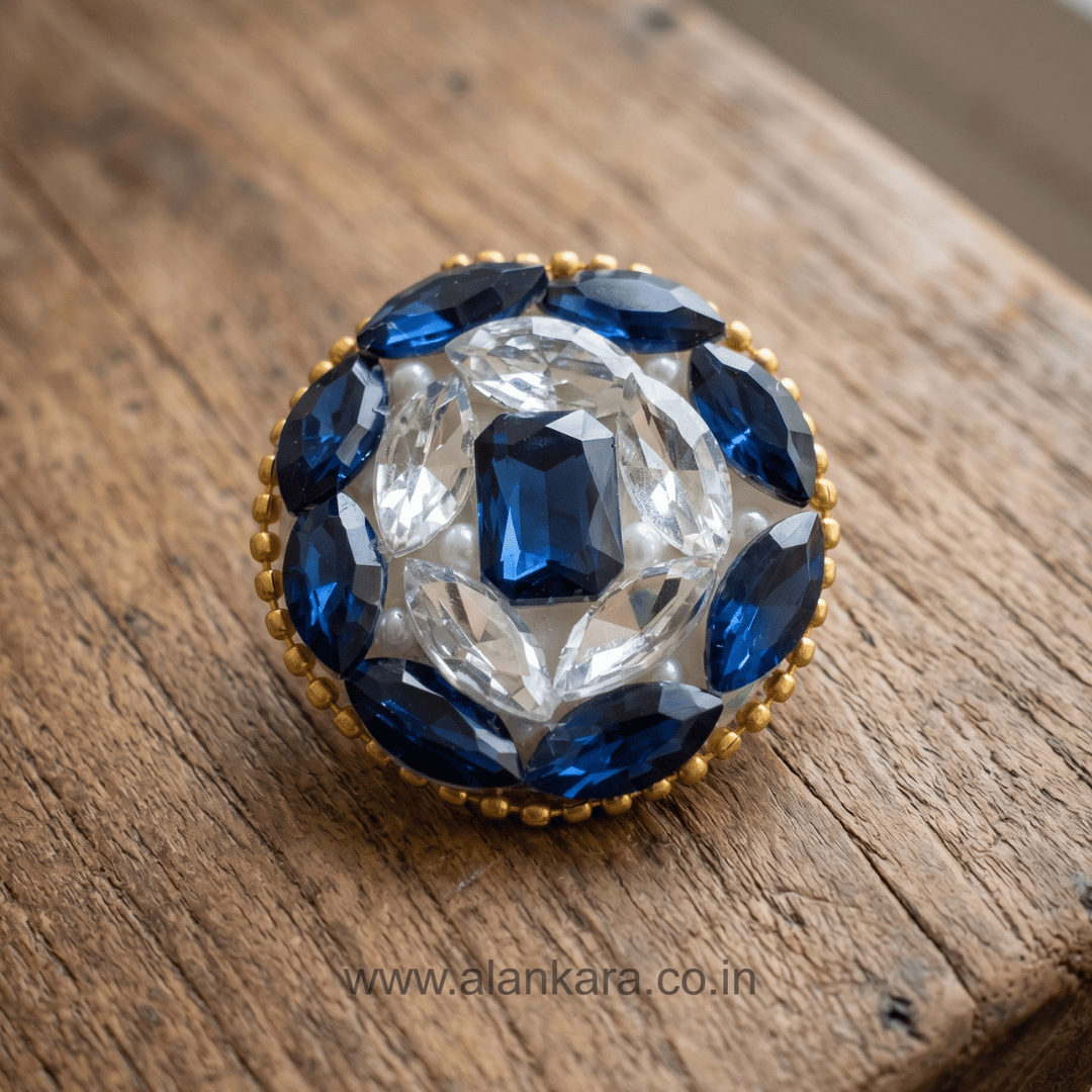 Royal Blue Crystal Pearl Saree Pin with intricate beadwork and stunning blue and white crystals on a wooden surface.