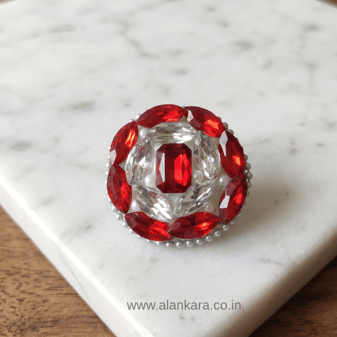Ruby Red Crystal Saree Pin showcasing sparkling red and white crystals on a marble background.