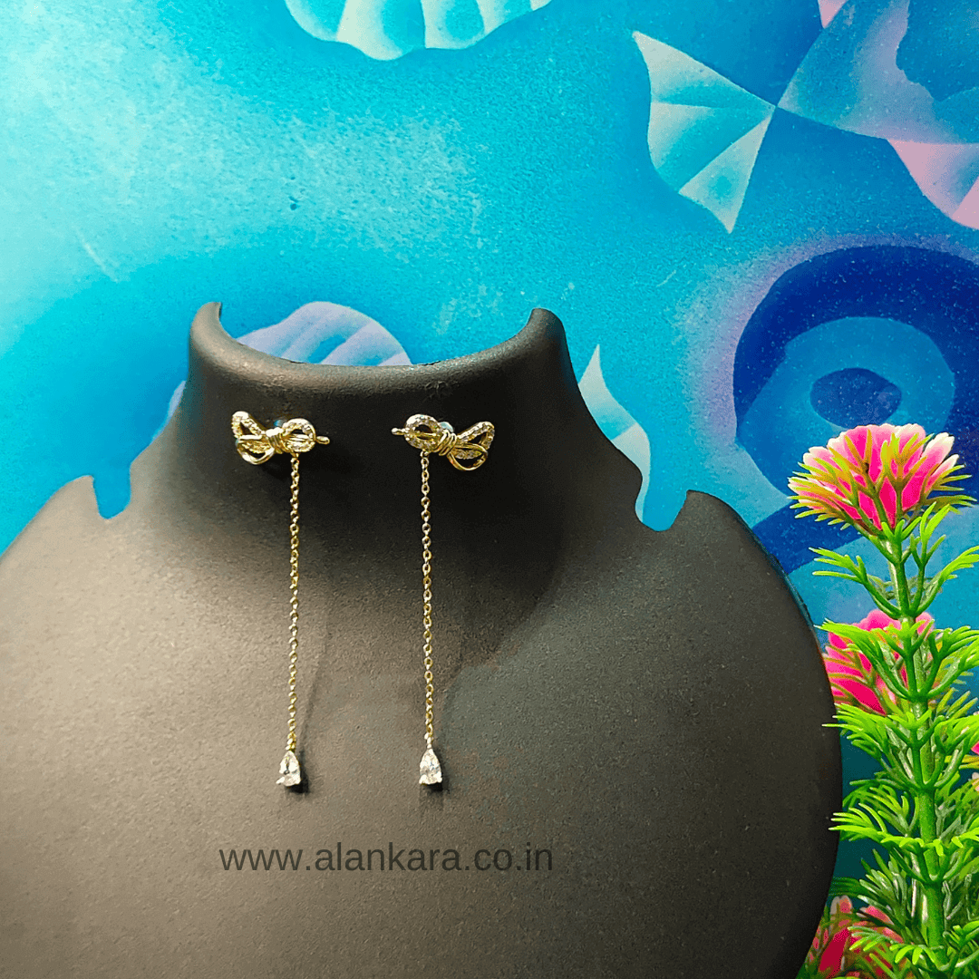 White bow dangler earrings