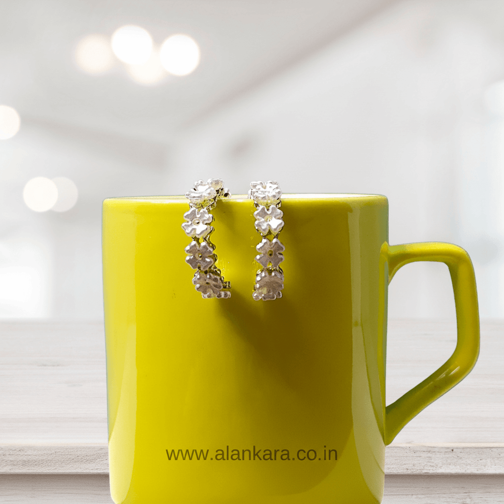 White Golden Pearl Hoop earrings displayed on a bright yellow mug, perfect for stylish outfits.