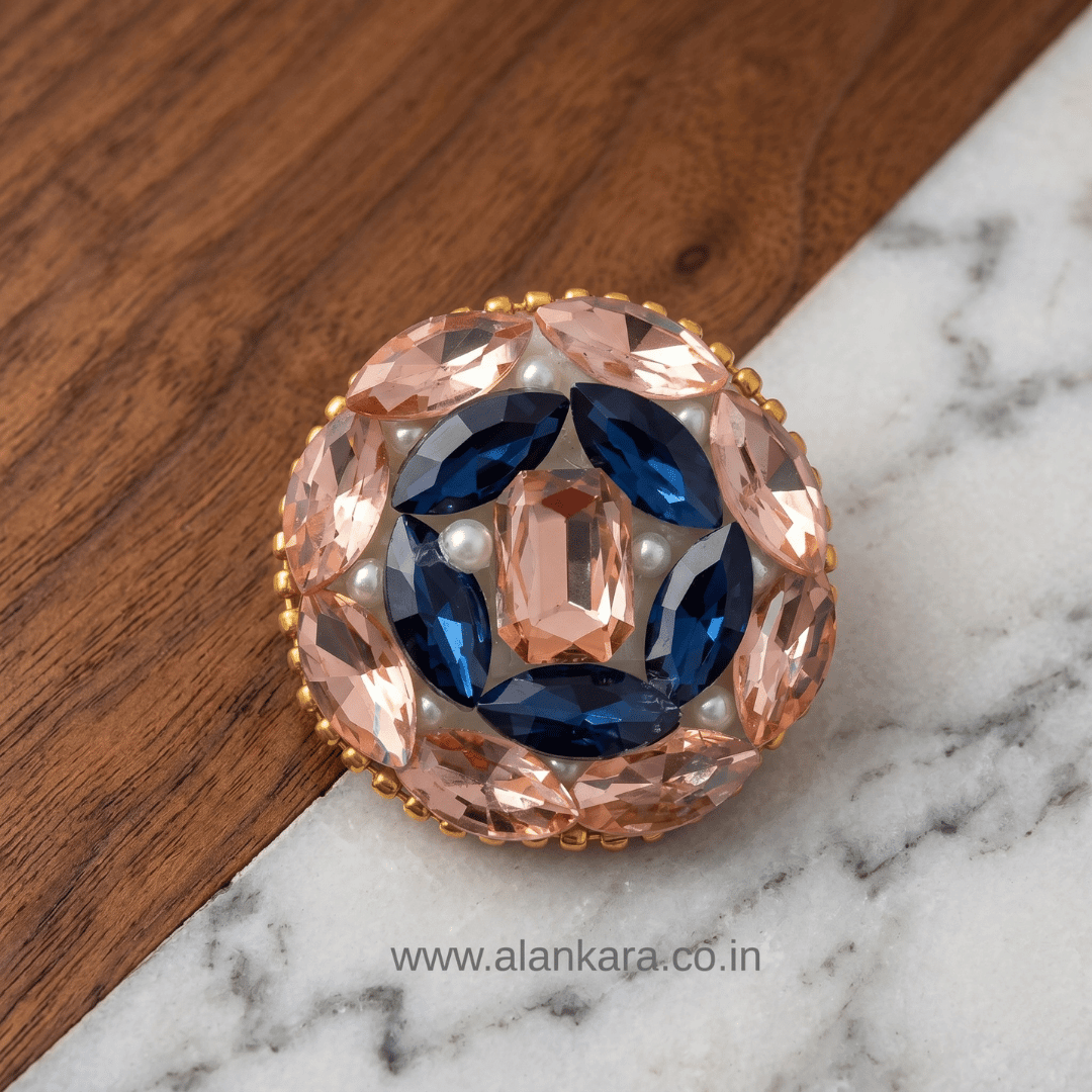 Peach & Blue Crystal Pearl Saree Pin featuring intricate design with blue and peach crystals.