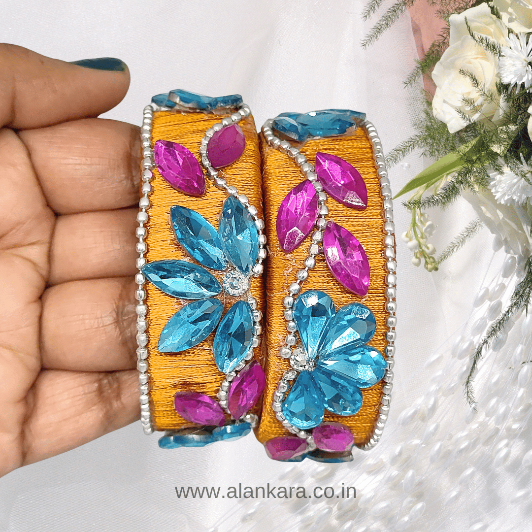 Mustard Floral Crystal Silk Thread Kada Bangles featuring aqua blue floral stones and pink marquise crystals on a silk thread base.