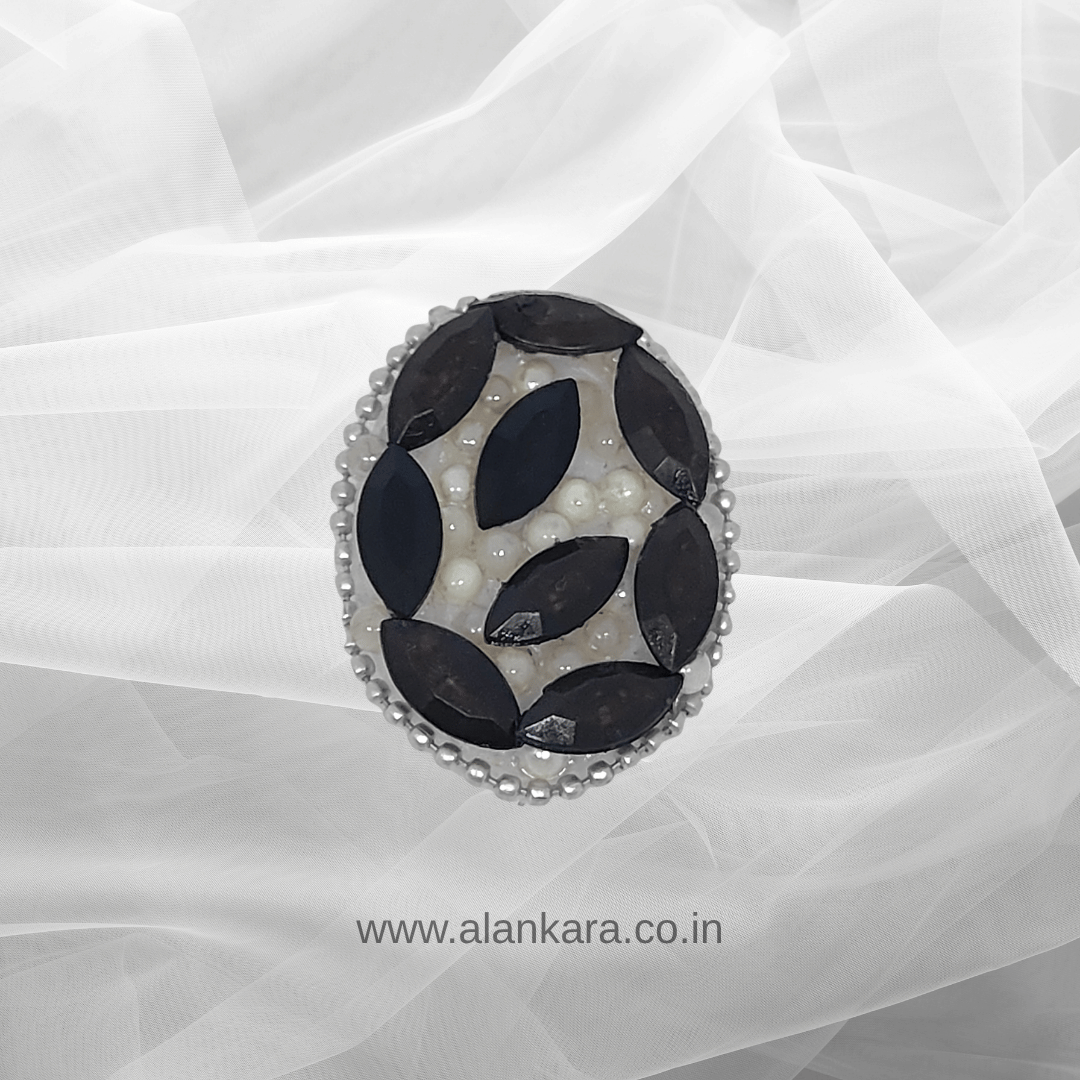 Black Crystal Pearl Saree Pin showcasing black crystals and pearls on a delicate background.