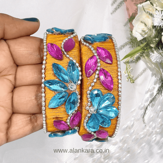 Mustard Floral Crystal Silk Thread Kada Bangles featuring aqua blue floral stones and pink marquise crystals on a silk thread base.