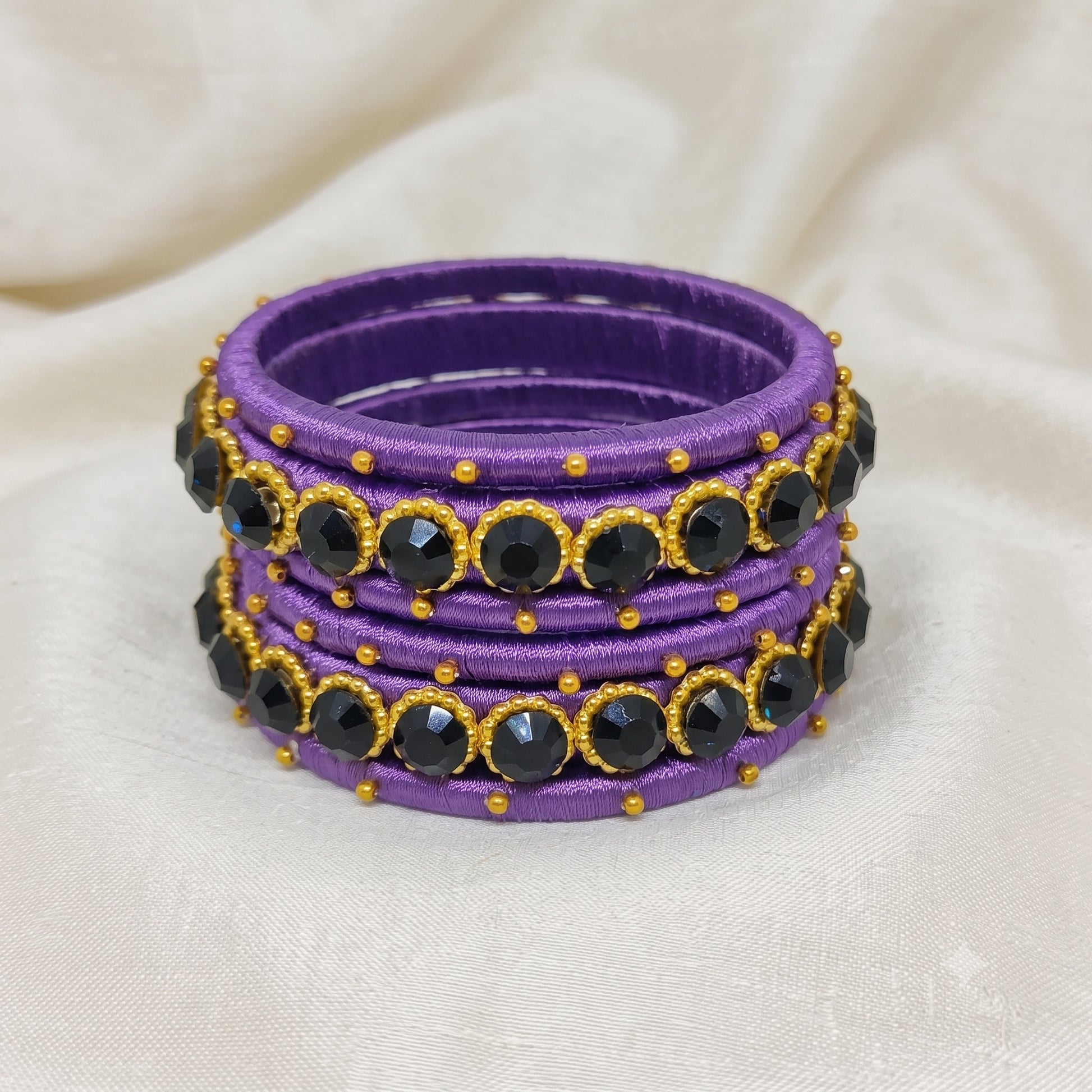 Royal Purple crystal Silk thread bangles featuring black crystal accents and golden bead detailing.