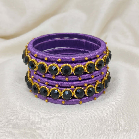 Royal Purple crystal Silk thread bangles featuring black crystal accents and golden bead detailing.
