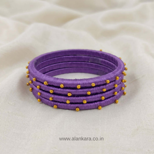 Royal Purple Golden Silk Thread Bangles featuring vibrant purple silk and golden beads, perfect for festive wear.