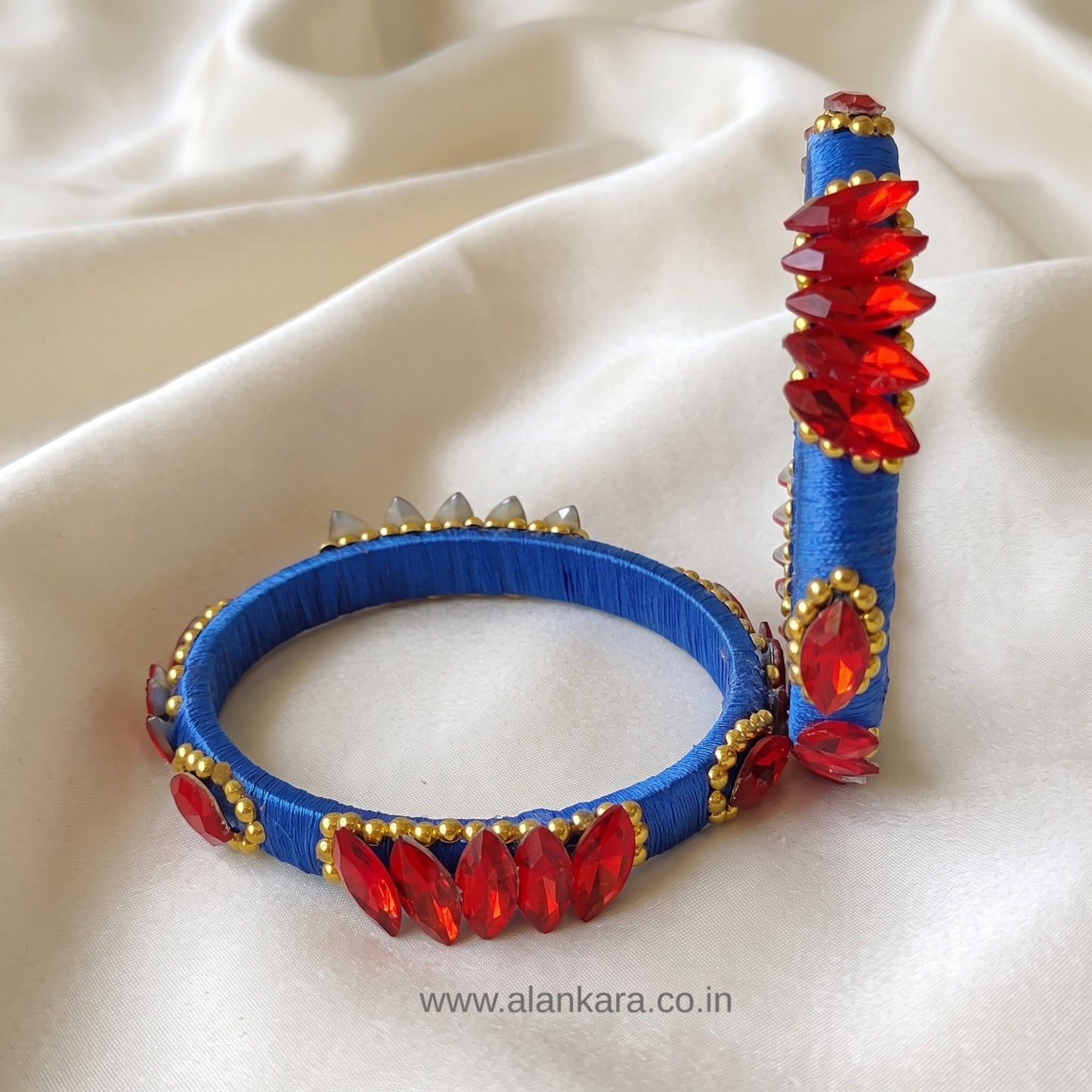 Royal Blue Red Crystal Silk Thread Kada Bangles showcasing royal blue silk thread and red crystals with golden bead detailing.