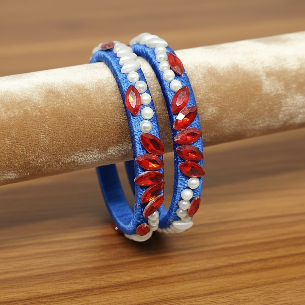Royal blue floral pearl crystal silk thread bangles on display showcasing their elegant design.