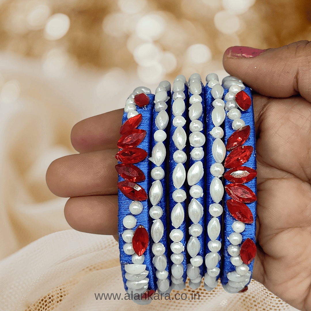Royal blue Pearl Crystal silk thread bangles featuring floral patterns with pearls and red crystals.