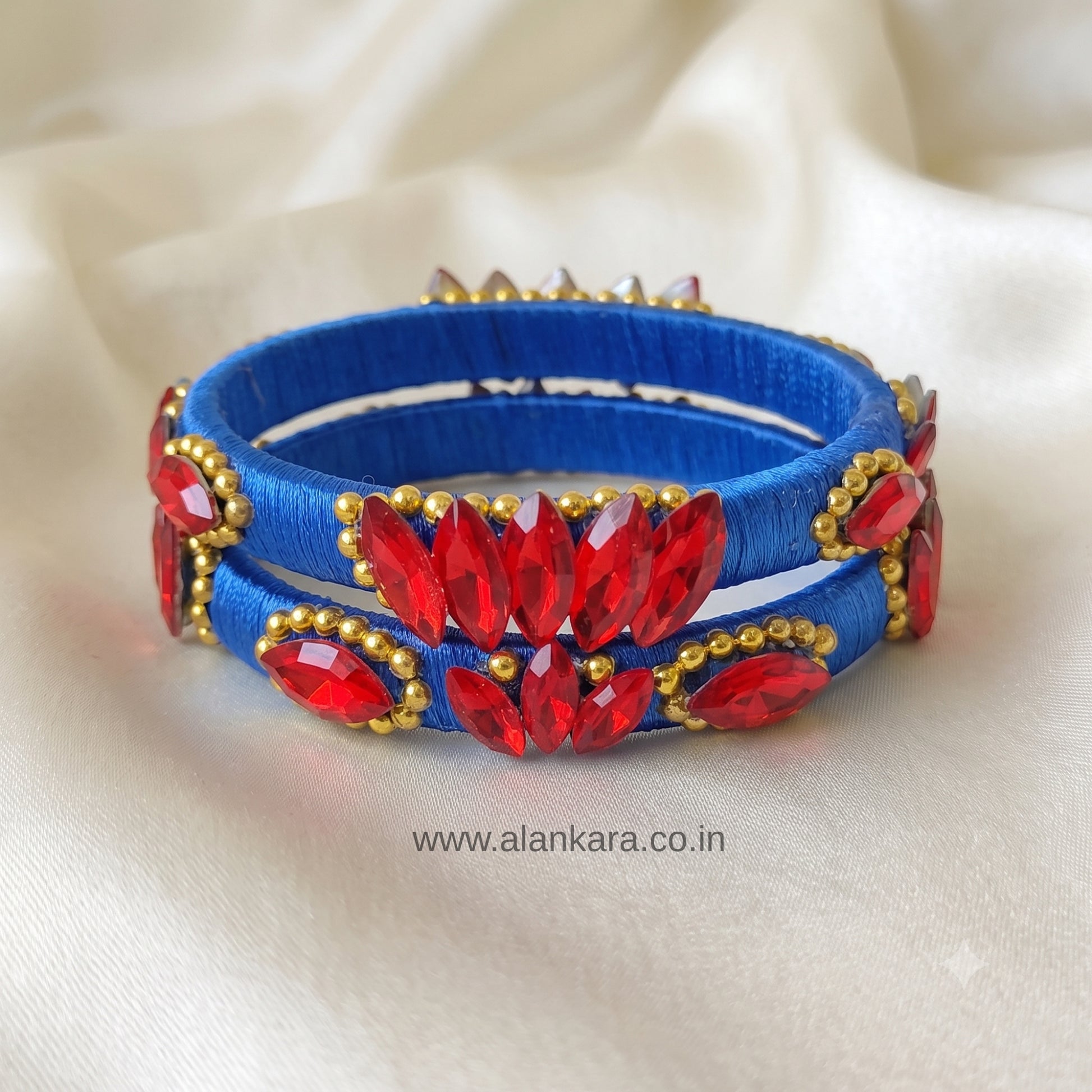 Royal Blue Red Crystal Silk Thread Kada Bangles adorned with vibrant red crystals and golden beads.