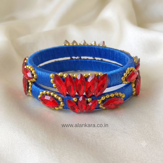 Royal Blue Red Crystal Silk Thread Kada Bangles adorned with vibrant red crystals and golden beads.