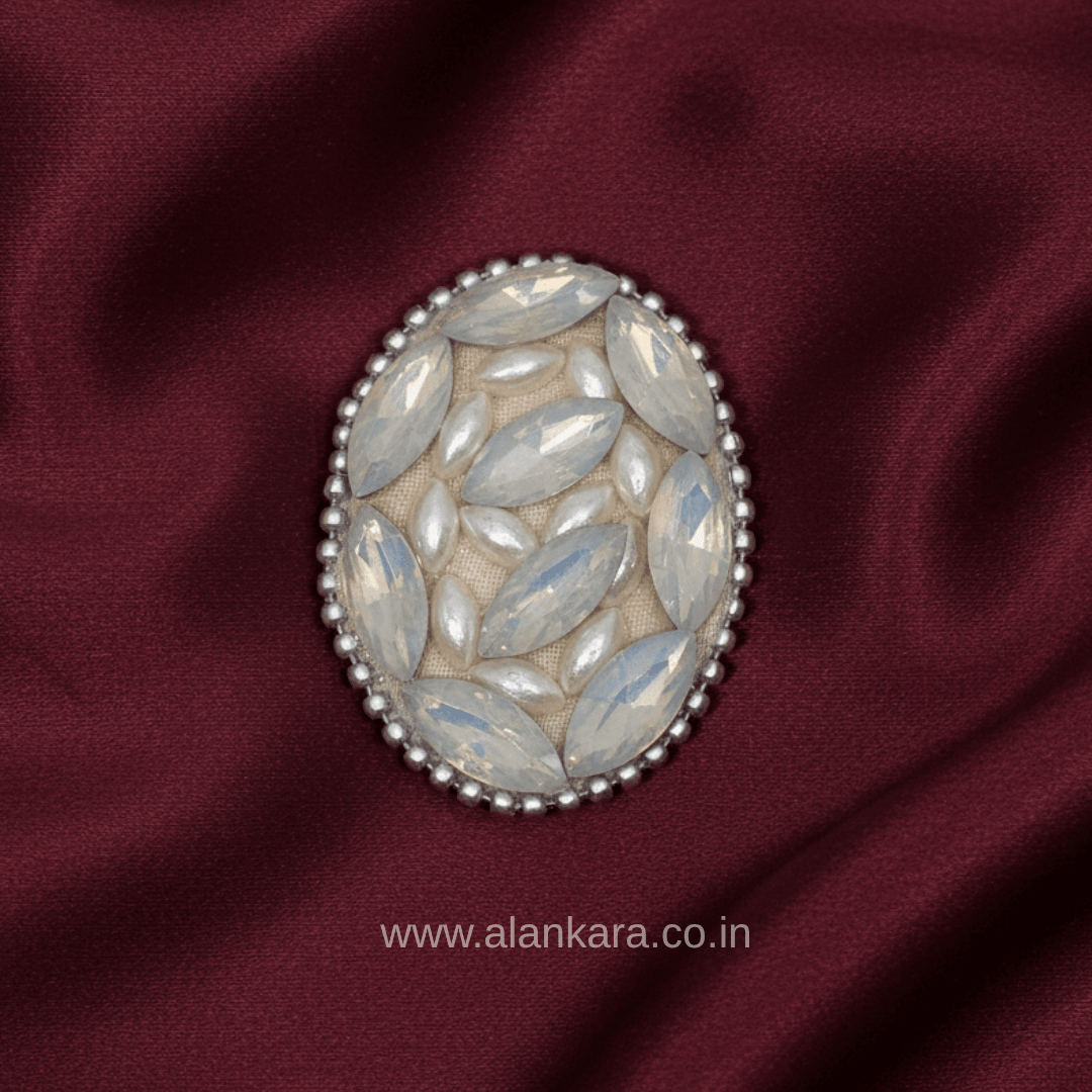 White Pearl Crystal Saree Pin showcasing elegant marquise-shaped crystals on a rich maroon fabric.