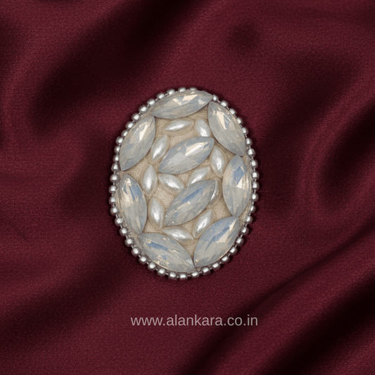 White Pearl Crystal Saree Pin showcasing elegant marquise-shaped crystals on a rich maroon fabric.
