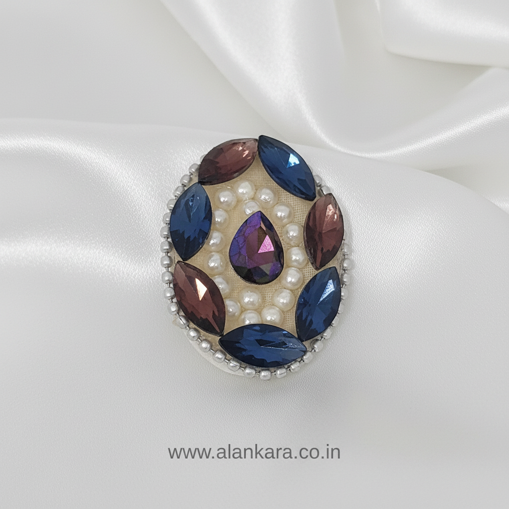 Wine Blue Crystal Pearl Saree Pin with intricate jewel design on satin fabric.