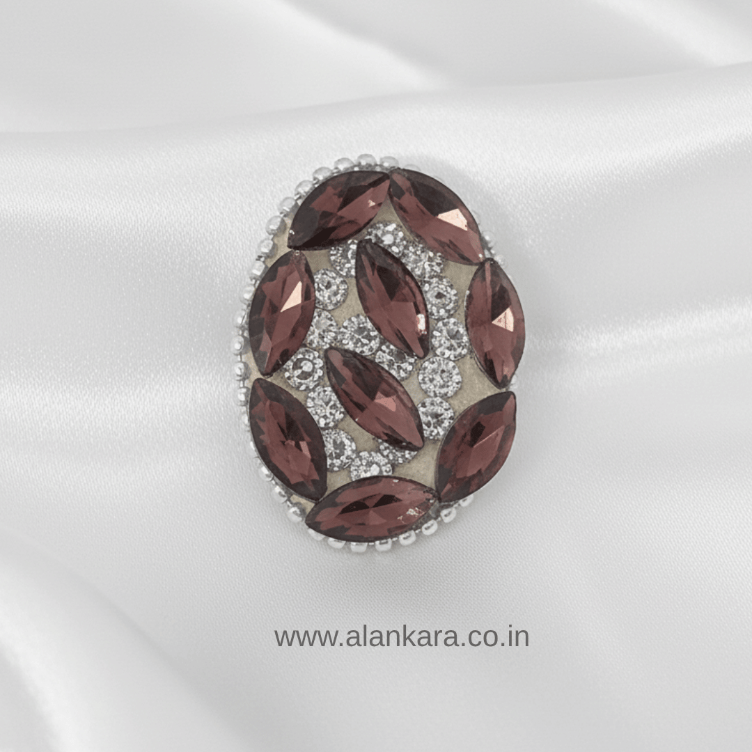 Wine Crystal Noori Saree Pin showcasing rich wine crystals and sparkling noori stones on a satin background.