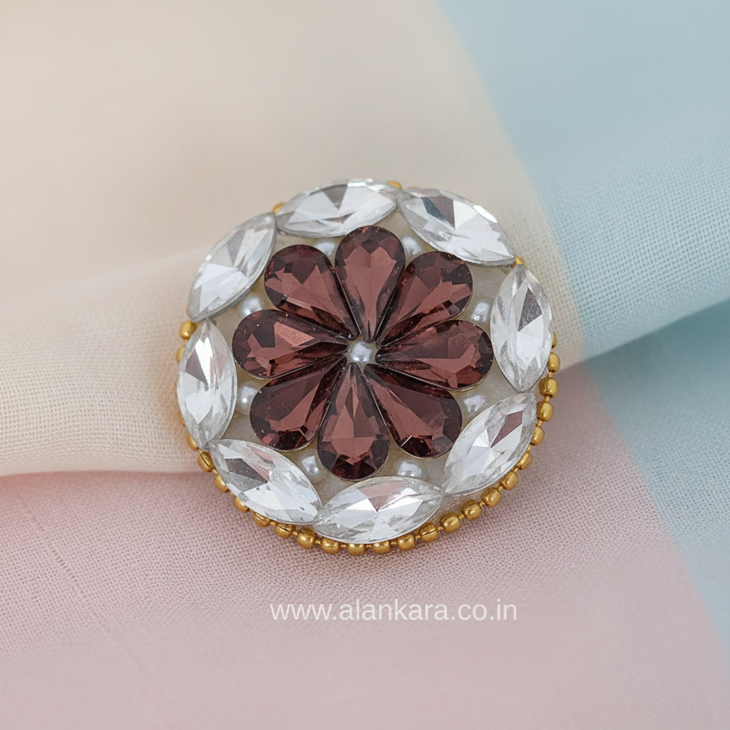 Wine Floral Crystal Pearl Saree Pin with floral design and sparkling crystals on a pastel fabric backdrop.