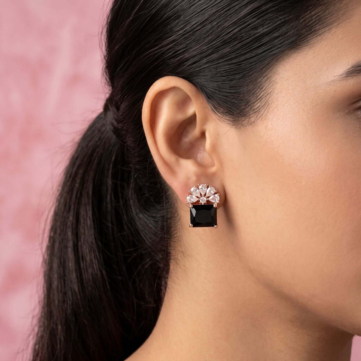 Model wearing Black Floral Crystal Stud earrings, showcasing a black square stone and floral design accents.