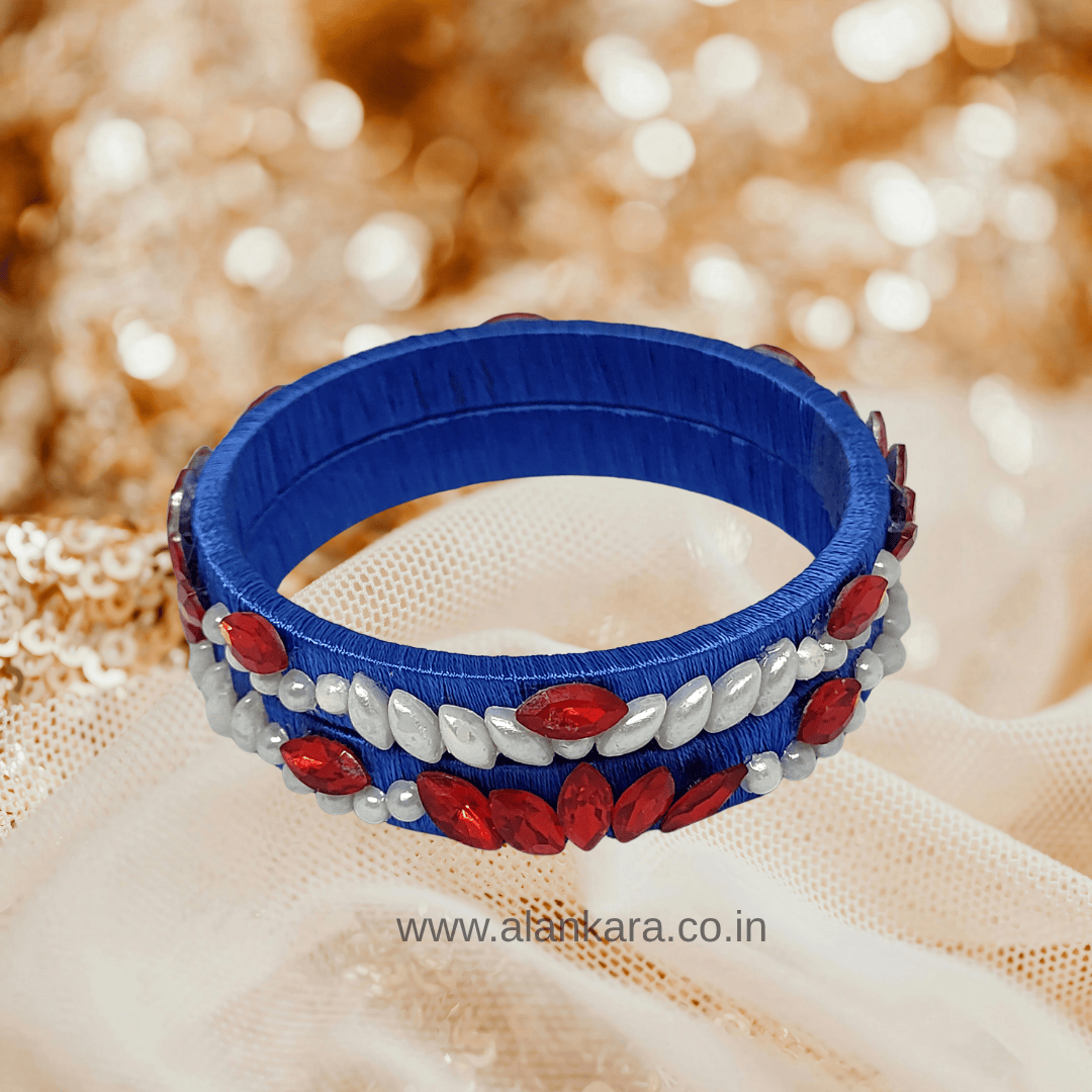 Royal blue floral pearl crystal silk thread bangles with white pearls and red crystals.