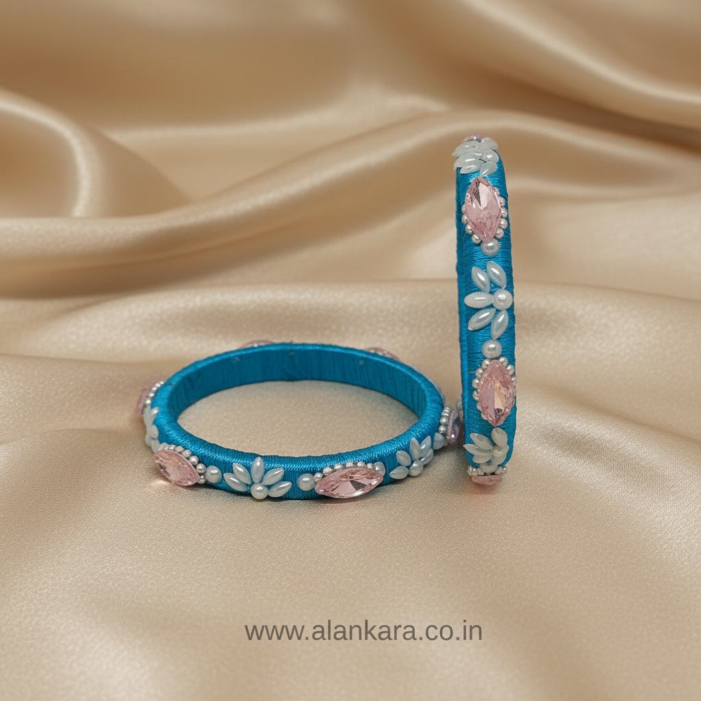 Blue Pearl Crystal Silk Thread Kada Bangles on a soft satin background, showcasing intricate detailing and vibrant colors.