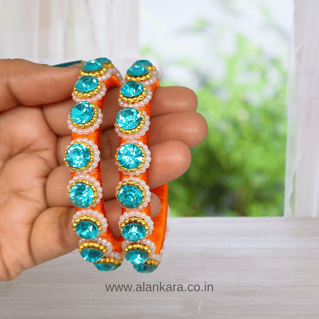 Orange & Blue Pearl Silk Thread Kada Bangles featuring orange silk base and sparkling blue crystals.