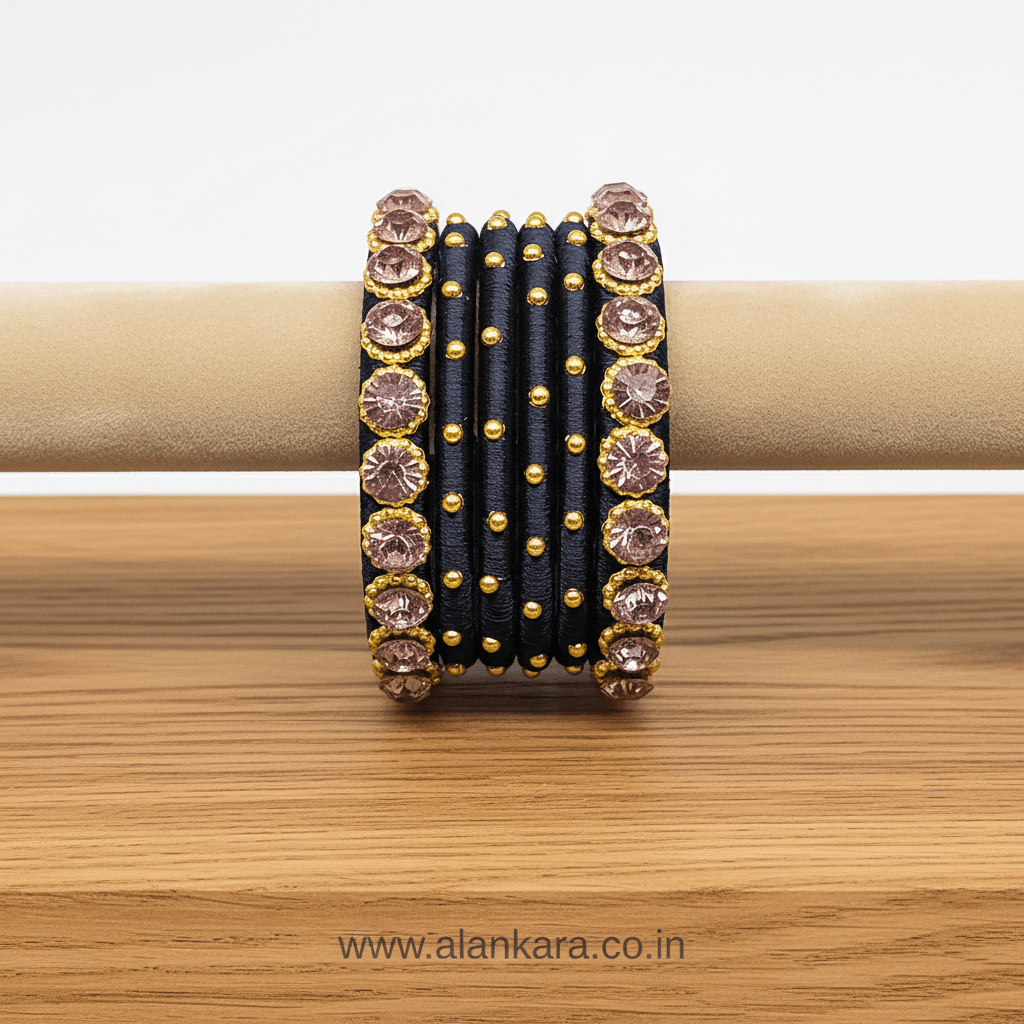 Navy Blue Pink Crystal Silk Thread Bangles adorned with pink crystals and golden beads on a wooden display.