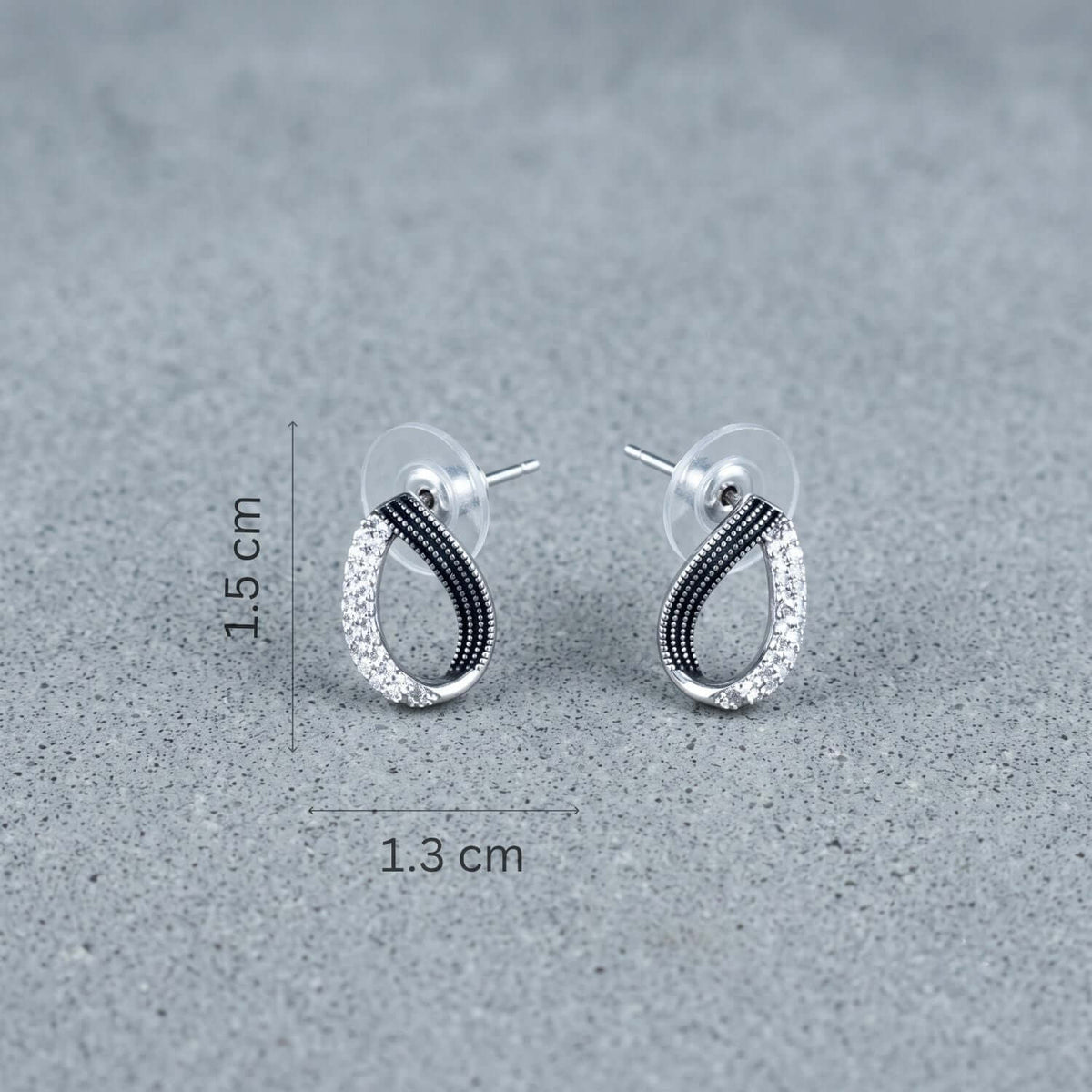 Black White Eye Stud earrings with gold plating and dimensions of 1.5 cm x 1.3 cm.