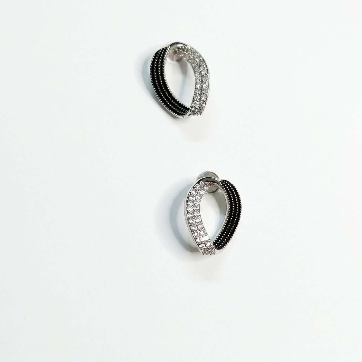 Black White Eye Stud earrings featuring a sleek design with black and white accents and sparkling details.
