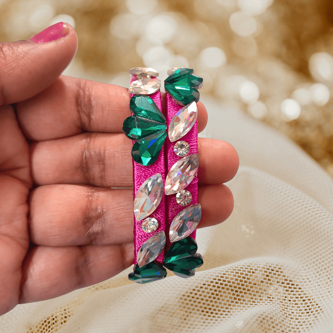Rani pink floral crystal silk thread bangles featuring sparkling green and white crystals on vibrant pink thread.