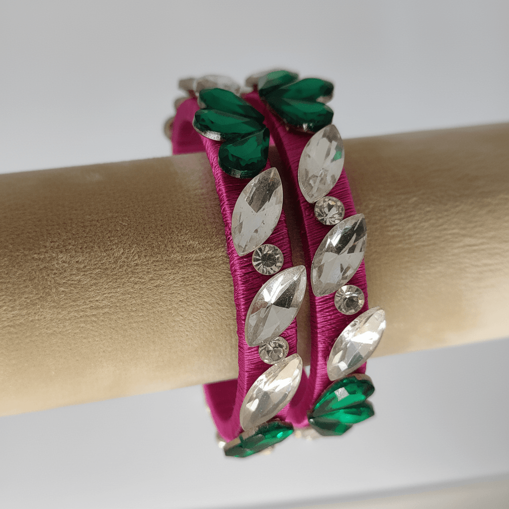 Rani pink floral crystal silk thread bangles featuring white and green crystals on a vibrant pink silk thread.