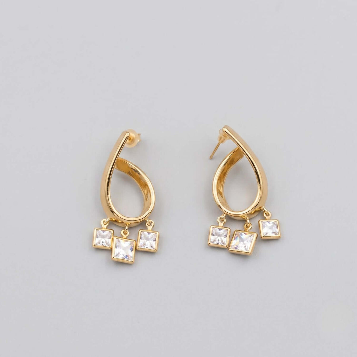 Elegant Golden Curve Crystal Hoop earrings featuring sparkling crystals, perfect for various outfits.