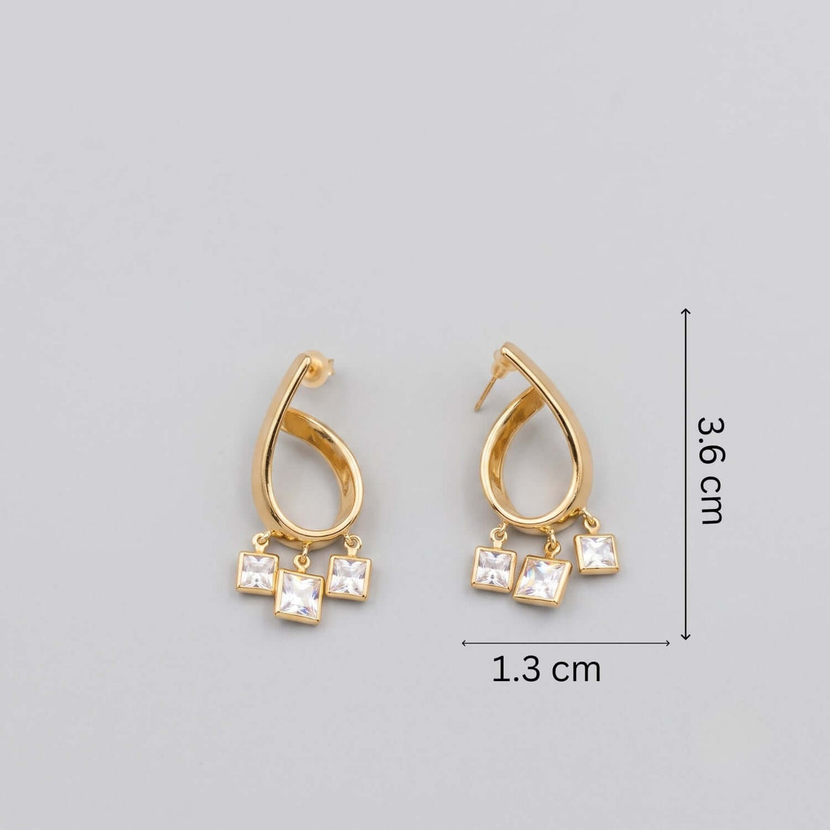 Golden curve Crystal Hoop earrings featuring a unique gold design with dangling crystals, dimensions 3.6 cm x 1.3 cm.