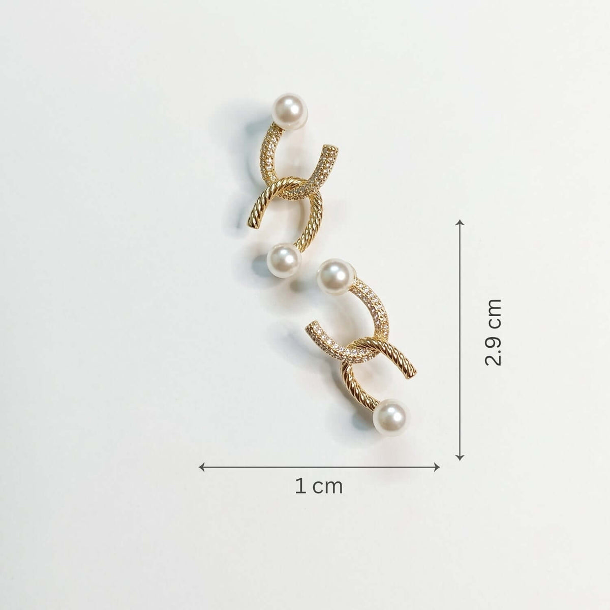 Golden Curve Pearl Stud earring featuring cubic zirconia and pearls, perfect for Indian and western outfits, dimensions 2.9x1 cm.