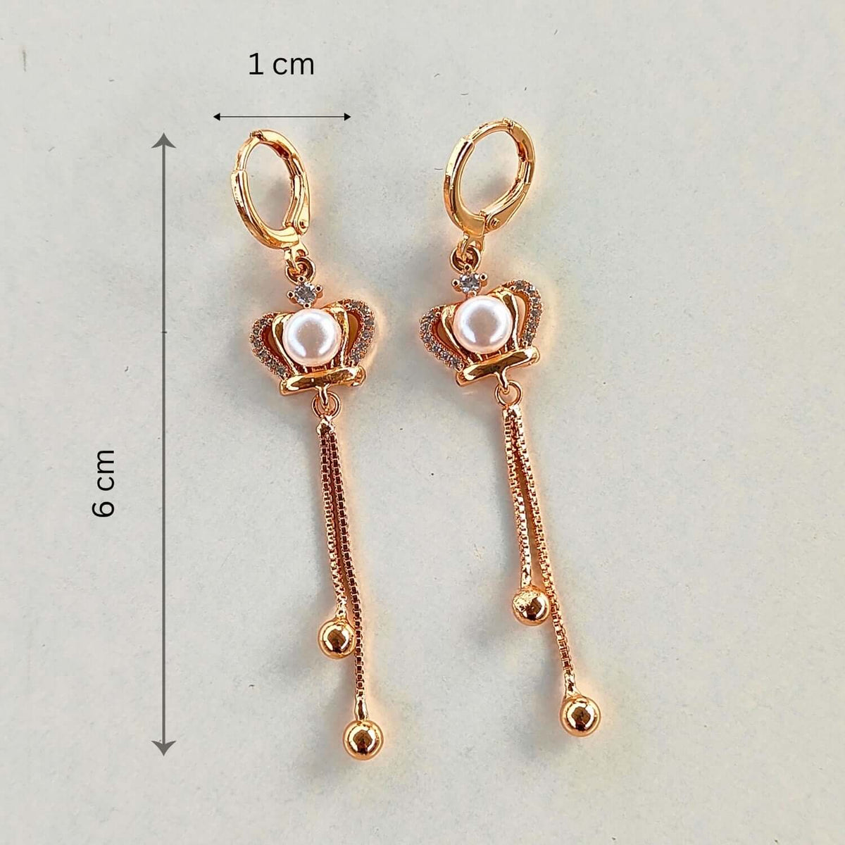 Golden Pearl Heart dangler earrings showcasing a pearl and gold design with a stylish dangler feature.