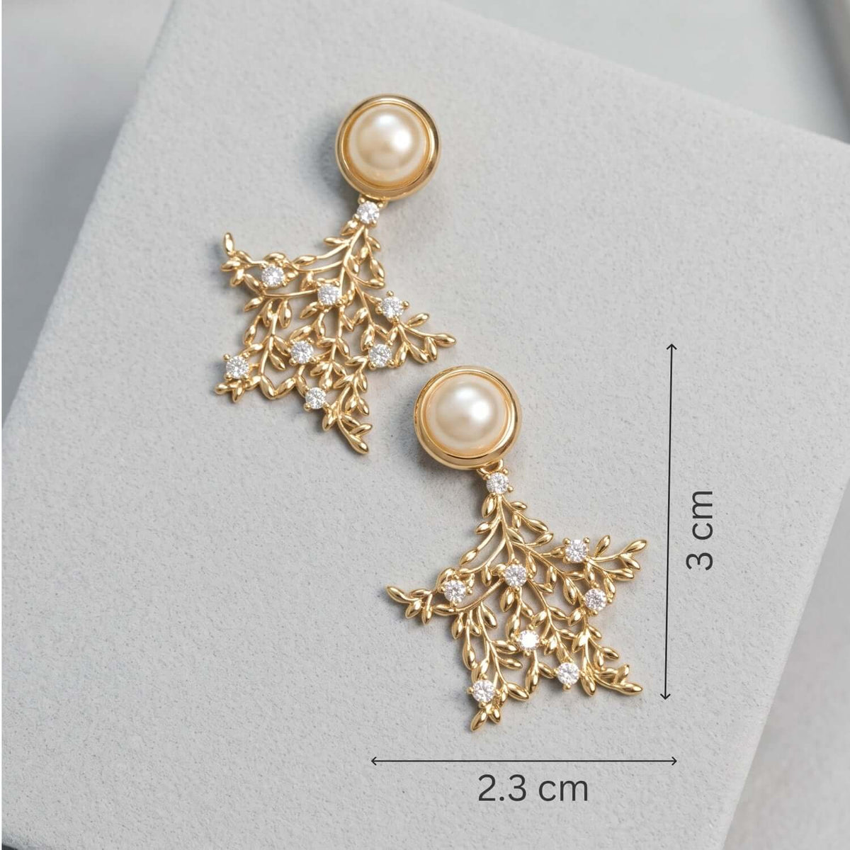 Golden Pearl Leaf Stud earrings featuring gold alloy design with pearl and crystal details, measuring 2.3 cm by 3 cm.