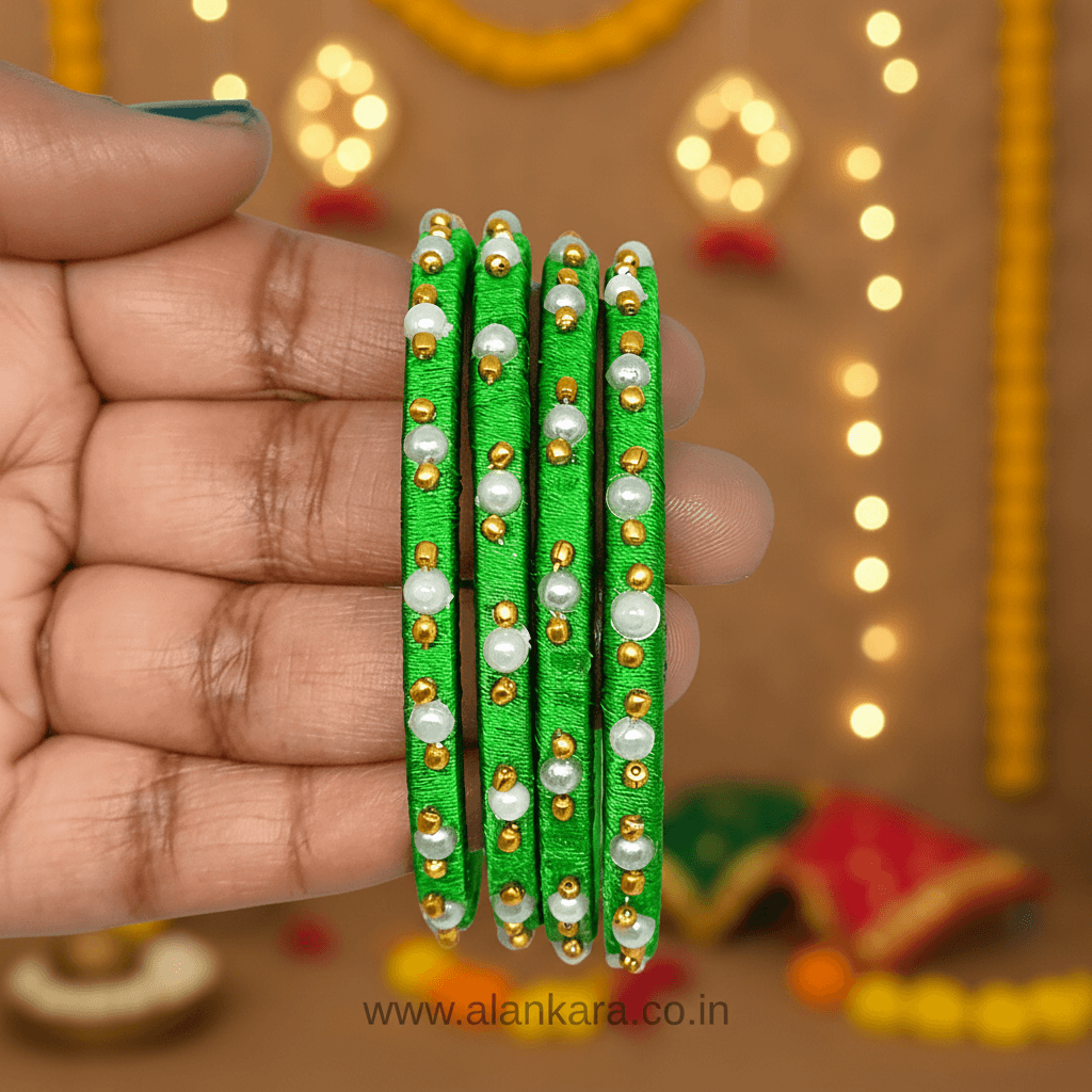 Green Pearl Silk Thread Bangles held in a hand, showcasing vibrant green silk, white pearls, and golden beads.