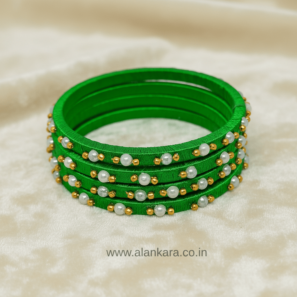 Green Pearl Silk Thread Bangles showcasing vibrant green silk threads adorned with delicate white pearls and golden beads.