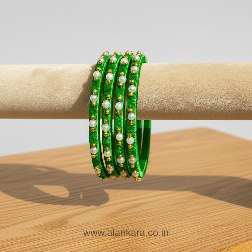 Green Pearl Silk Thread Bangles elegantly displayed on a bracelet stand, featuring vibrant green silk and delicate pearls.