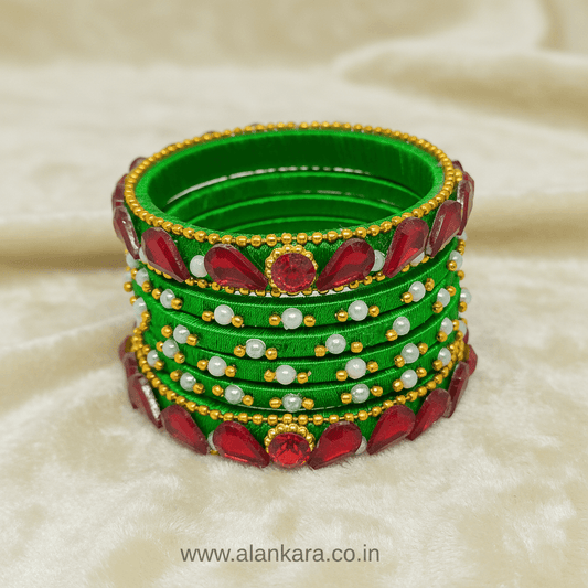 Green & Red Crystal Silk Thread Bangles showcasing vibrant green silk, red crystals, pearls, and golden beads.