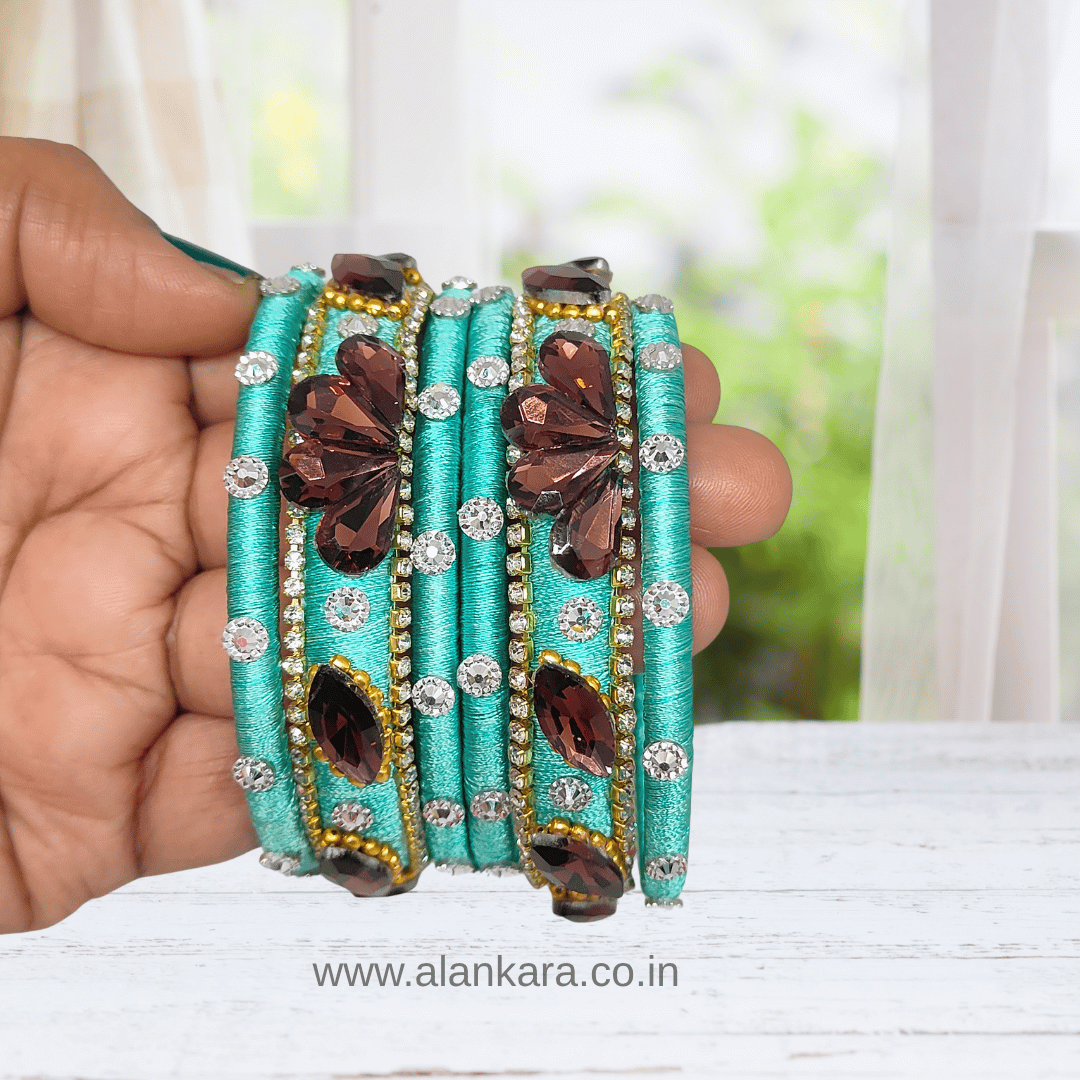 Pista Green Crystal Noori Silk Thread Bangles, embellished with wine crystals and silver-toned AD stones.