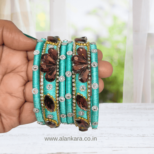 Pista Green Crystal Noori Silk Thread Bangles, embellished with wine crystals and silver-toned AD stones.