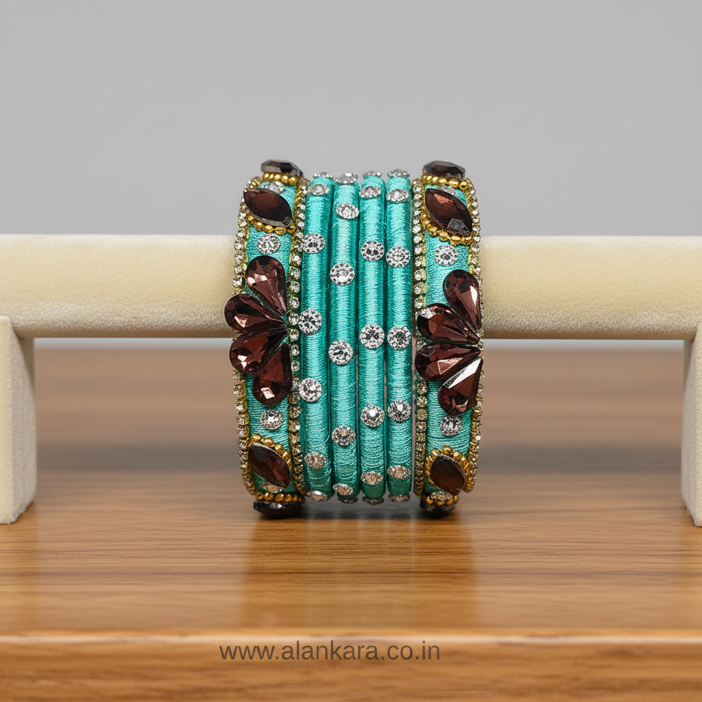 Pista Green Crystal Noori Silk Thread Bangles with wine crystals and silver-toned AD stones on display.