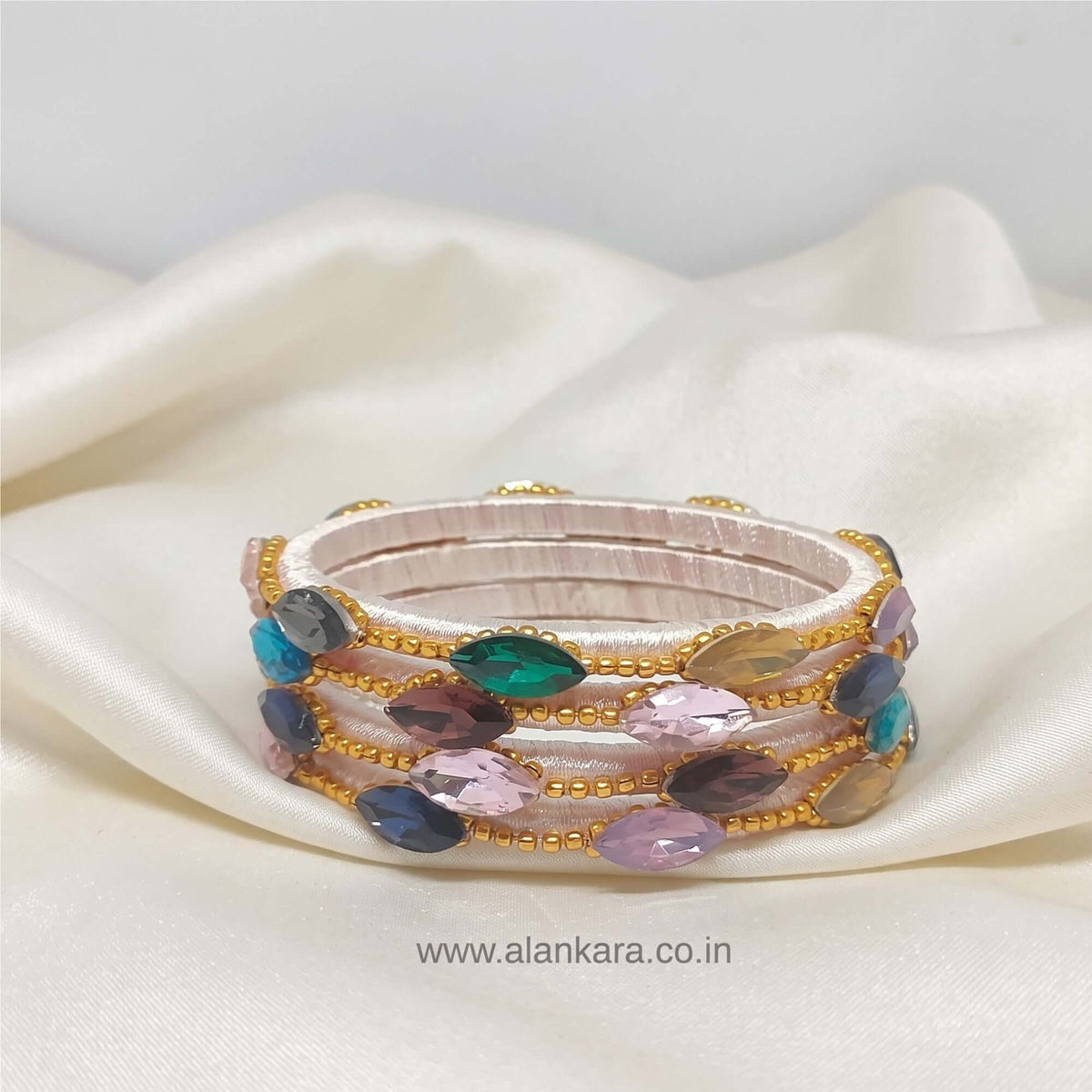Multicolor White Silk Thread Bangles featuring colorful crystal stones and golden bead detailing.
