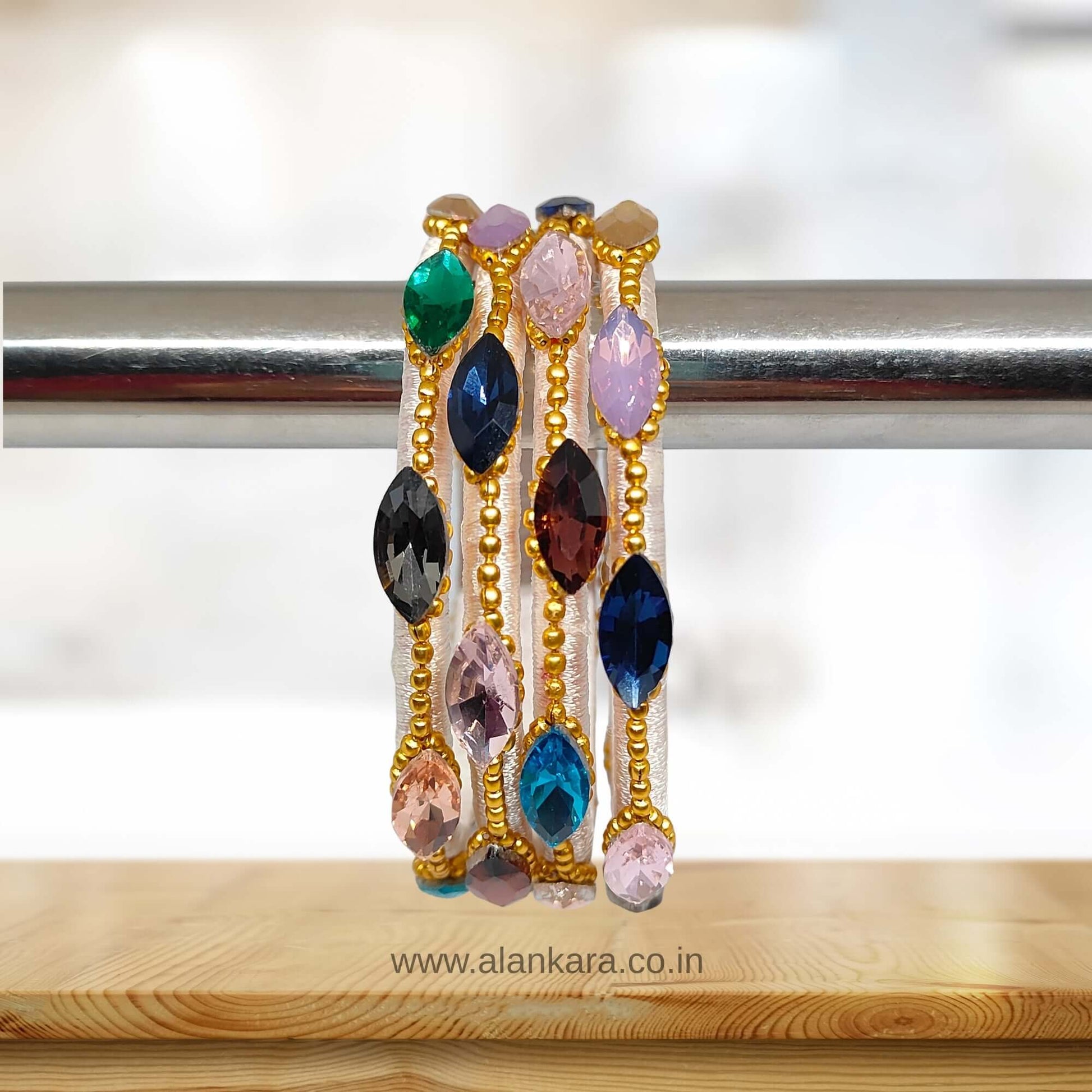 Multicolor White Silk Thread Bangles featuring colorful crystal stones and golden bead detailing.