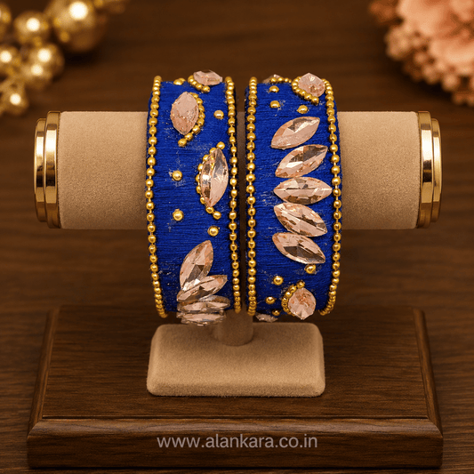 Navy Blue Peach Crystal Silk Thread Kada Bangles elegantly displayed on a wooden stand, showcasing marquise crystals and golden beads