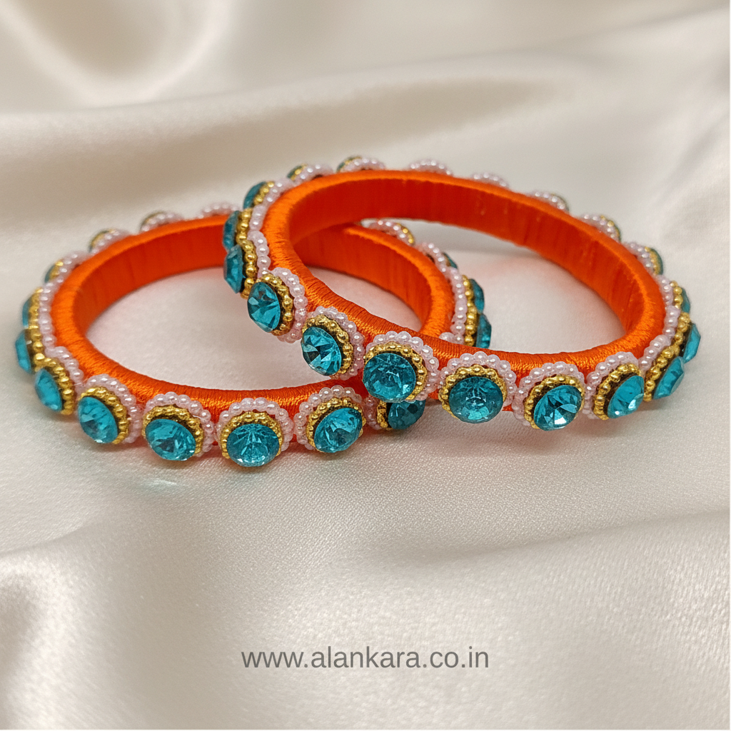 Orange & Blue Pearl Silk Thread Kada Bangles showcasing vibrant orange silk thread and sparkling blue crystals.