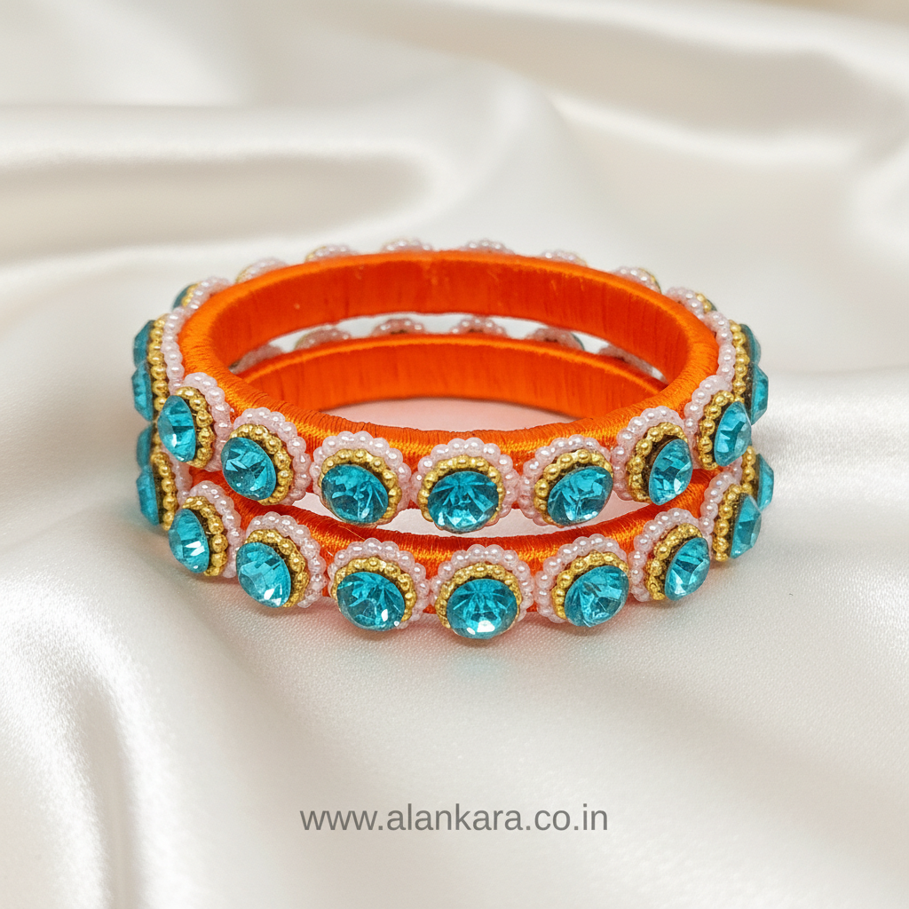 Orange & Blue Pearl Silk Thread Kada Bangles with vibrant orange silk base and sparkling blue crystals.
