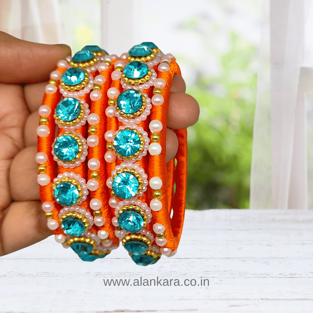 Orange & Blue Pearl Silk Thread Bangles showcasing vibrant orange silk and sparkling blue crystals, perfect for festive occasions.