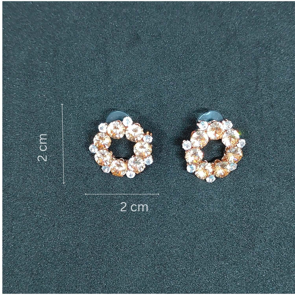 Peach Crystal Stud earrings with golden alloy and cubic zirconia, measuring 2 cm each.
