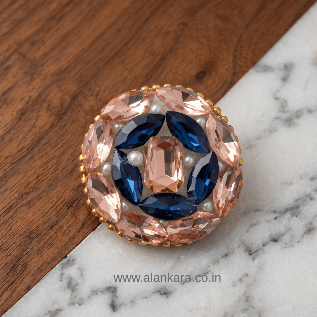 Peach & Blue Crystal Pearl Saree Pin featuring intricate design with blue and peach crystals.